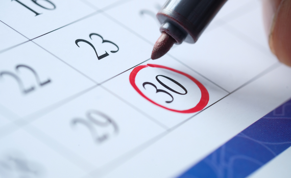 Graphic shows a paper desk calendar with a person circling a date with a red marker.